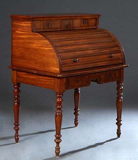 French Carved Walnut Roll Top Desk, 19th c., with two small drawers over a tambour top enclosing three open shelves and a pull out baize lined writing