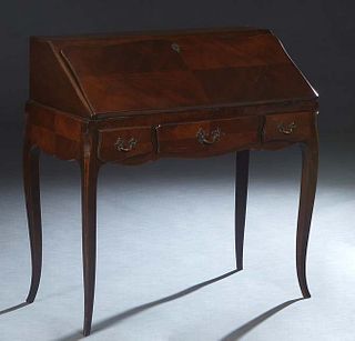French Louis XV Style Carved Cherry Slant Front Secretary, 20th c., the serpentine edge lid with an inset gilt tooled red leather writing surface open