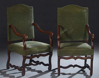 Pair of Louis XIII Style Carved Oak Fauteuils a la Reine, 20th c., the arched canted upholstered back flanked by scrolled arms, to a cushioned seat on