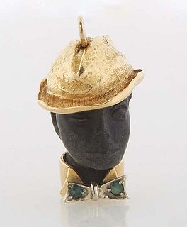 18K Yellow Gold Blackamoor Pendant, 20th c., with a gold hat on a carved ebony head, with a gold collar and a white gold bow tie mounted with two roun