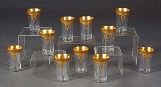 Set of Eleven Moser Style Juice Glasses, early 20th c., the everted rim with a wide gilt band with floral garlands, over tapered sides with a bottom g