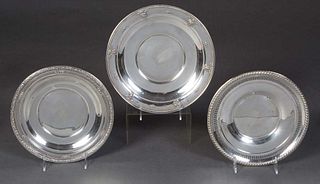 Three Circular Sterling Plates, 20th c., consisting of a reticulated example by Rogers, with a relief gadroon border, H.- 1/2 in., Dia.- 9 in., Wt.- 4
