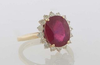 Lady's 14K Yellow Gold Dinner Ring, with an oval 5.26 carat ruby atop a border of round diamond "points," total diamond weight- .65 cts., size 7.