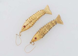 Pair of 14K Yellow Gold Reticulated Pierced Fish Earrings, 20th c., the eyes mounted with red stones, H.- 2 in., .- 1/2 in., D.- 5/16 in., Wt.- .23 Tr