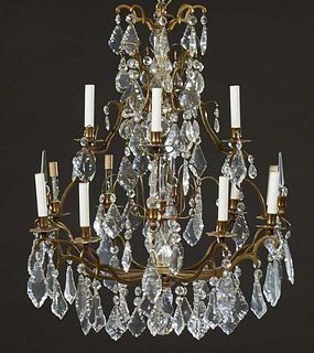 French Gilt Bronze and Crystal Eight Light Chandelier, late 19th c., hung with button and pendalogue crystal prisms and mounted with two crystal spire