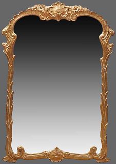 Carved Gilt and Gesso Overmantel Mirror, 20th c., with a shell carved crest over a scrolled reeded frame, around a mirror plate, H.- 42 in., W.- 28 in