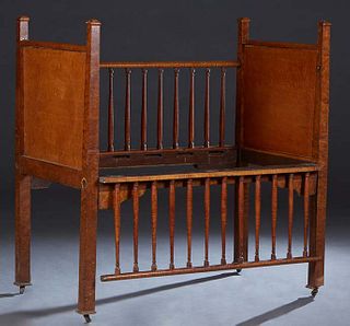 American Late Classical Figured and Bird's-Eye Maple Crib, late 19th c., the paneled head and footboards joined by side rails with open square spindle