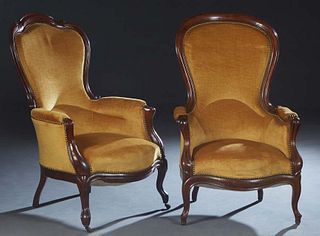 Pair of French Louis Philippe Carved Walnut Armchairs, 19th c., the canted arched curved upholstered high back over upholstered arms and a bowed uphol
