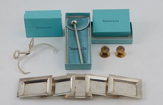 Lot of Nine Tiffany Sterling Items, consisting of five nut dishes, #20598, a pair of ice cube tongs, two shell form place card holders, and a swizzle 