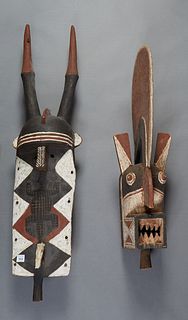 Two Large Polychromed Wood African Masks, 20th c., one of a horned figure, H.- 47 1/2 in., W.- 12 in., D.- 9 in.; together with a bird form mask with 
