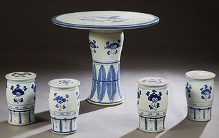 Chinese Porcelain Five Piece Patio Set, 20th c., consisting of a circular table with fish decoration and four blue and white cylindrical stools, H.- 2