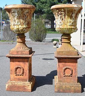 Pair of Large Iron Urns on Pedestals, having classical figures, all set on square pedestals with wreaths, pedestal height 32 inches, total height 82 i