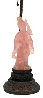 Carved Pink Quartz Figure of a Guanyin, standing figure wearing a robe and holding a vase of flowers, made into table lamp, height 19 inches.