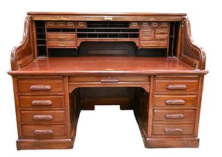 Mahogany Derby Desk, having S roll top with hinged wings, 19 drawered interior, raised panels and carved pulls, marked Derby Desk Boston, Mass., USA, 