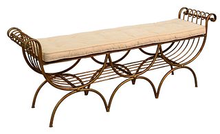 Iron Window Bench, having gilt gold paint with cushion top, height 24 inches, length 62 inches.