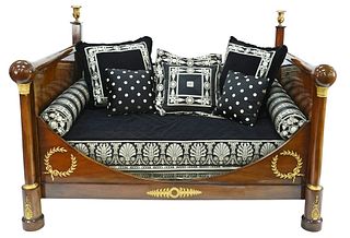 French Empire Mahogany Daybed, having gilt urn top, bronze mounts and capitals, custom upholstered mattress, pillows and bolsters, interior dimensions