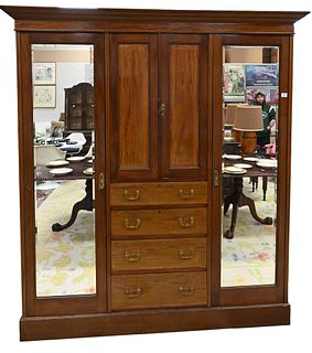 Edwardian Mahogany Armoire, having two large doors, drawers, and small doors, height 76 inches, width 82 1/2 inches, depth 23 inches.