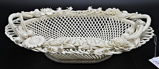 Belleek Porcelain Handled Basket, four strand, having flowers with twig handles, impressed mark on bottom, length 12 inches. Provenance: Collections o