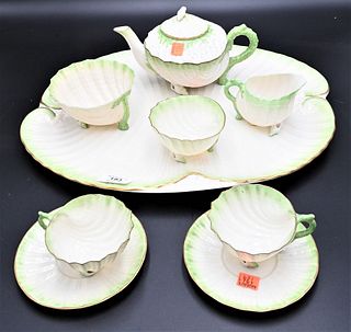 Nine Piece Belleek Neptune Porcelain Green Shell and Coral Form Tea Set, to include teapot, sugar, creamer, cups, saucers, and tray, having black mark