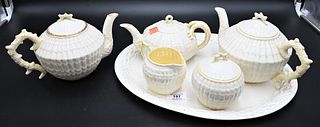 Six Piece Belleek Tea Set, to include three teapots, creamer, sugar, along with a large tray, having black mark, tray size 12" x 16". Provenance: Coll