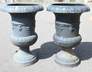 Pair of Iron Urns on Round Bases, height 35 inches, inside diameter 18 1/2 inches.