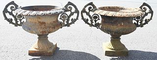 Pair of Large Iron Urns, having openwork handles on square footed bases, (one small chip in base), height 29 inches, width 47 inches, diameter 24 inch