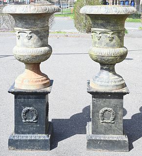Pair of Iron Urns on Square Pedestals, total height 60 inches, inside diameter 18 1/2 inches.