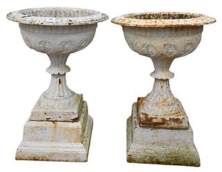 Pair of Victorian Iron Urns on Square Pedestals, total height 28 inches, inside diameter 15 inches.