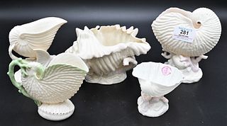 Five Belleek Shell Form Pieces, to include a conch shell on coral form base; shell on flying fish base; along with three shell form compotes; having b