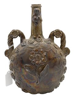 Ceramic Moon Flask, brown and green glazed, having twist handles, molded flowers and a figure on the neck, height 9 3/4 inches.