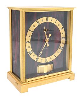 Jaeger LeCoultre Atmos Clock, embassy red, having faux marble panels, height 8 1/2 inches. Provenance: Collections of Norma Reilly, New Jersey.