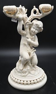 Large Belleek Boy Candelabra or Bud Vase, having cherub holding coral form branch with shelf form holders, brown mark to bottom, height 13 1/2 inches.