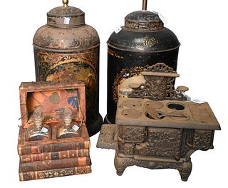 Pair of Tole Covered Canisters, made into lamps, iron doll stove, leather book, along with leather book decanter box, can height 18 inches. Provenance