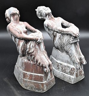 Pair of W. Manuelli Lead Garden Figures, art deco style of male and female satyr/satyress sitting and laughing on a tiered base, height 11 1/2 inches