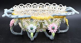 Belleek Porcelain Rathmore Basket, colorful flowers and leaves, branch handles, footed base, black mark on bottom, length 11 inches. Provenance: Colle