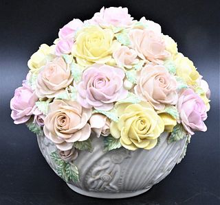 Belleek Rose Bowl, having encrusted colorful flowers in a bowl, having brown mark, height 6 inches. Provenance: Collections of Norma Reilly, New Jerse