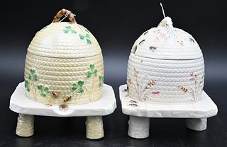 Two Belleek Honey or Bee Pots with Covers, both painted with black mark on bottom, height 5 3/4 inches. Provenance: Collections of Norma Reilly, New J
