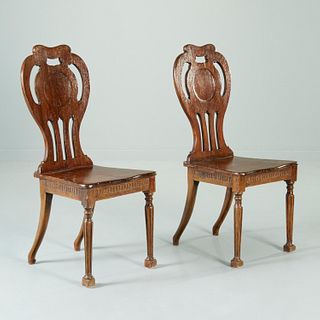 Pair George III carved mahogany hall chairs