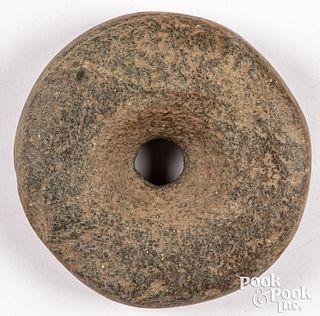 Ancient pierced discoidal stone
