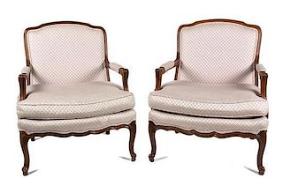 A Pair of Louis XV Style Carved Walnut Fauteuils Height 34 1/2 inches.