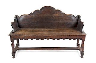 A French Provincial Carved Oak Bench Height 36 x width 53 3/4 x depth 16 1/2 inches.