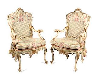 A Pair of Italian Rococo Style Carved and Painted Open Armchairs Height 43 1/4 inches.