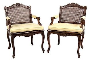 A Pair of Louis XVl Style Carved Walnut Fauteuils Height 35 inches.