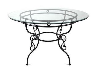 An Iron and Glass Outdoor Table Height 29 x diameter 48 inches.