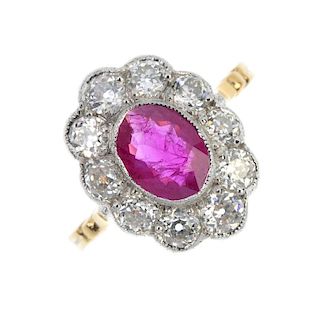 A ruby and diamond cluster ring. The oval-shape ruby collet, within an old-cut diamond surround, to