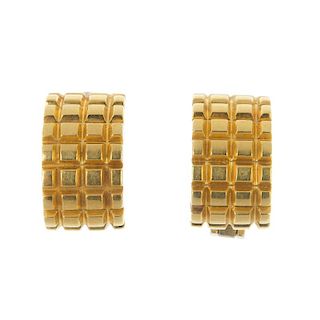 A pair of earrings. Each designed as a curved panel, with ridged decoration. Length 1.1cms. Weight 1