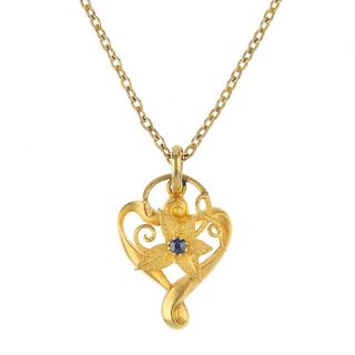 An Edwardian 15ct gold sapphire floral pendant. The textured flower with circular-shape sapphire hig