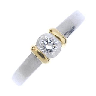 A platinum diamond single-stone ring. Of bi-colour design, the brilliant-cut diamond, with bar sides