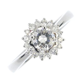 An 18ct gold diamond floral cluster ring. The brilliant-cut diamond, weighing 0.50ct, within a simil