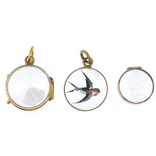 A selection of three early 20th century pendants. To include a gold rock crystal locket, a gold sphe